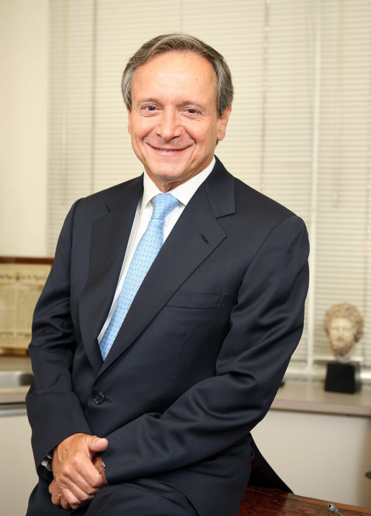 Dr. Albert Levy smiling in office