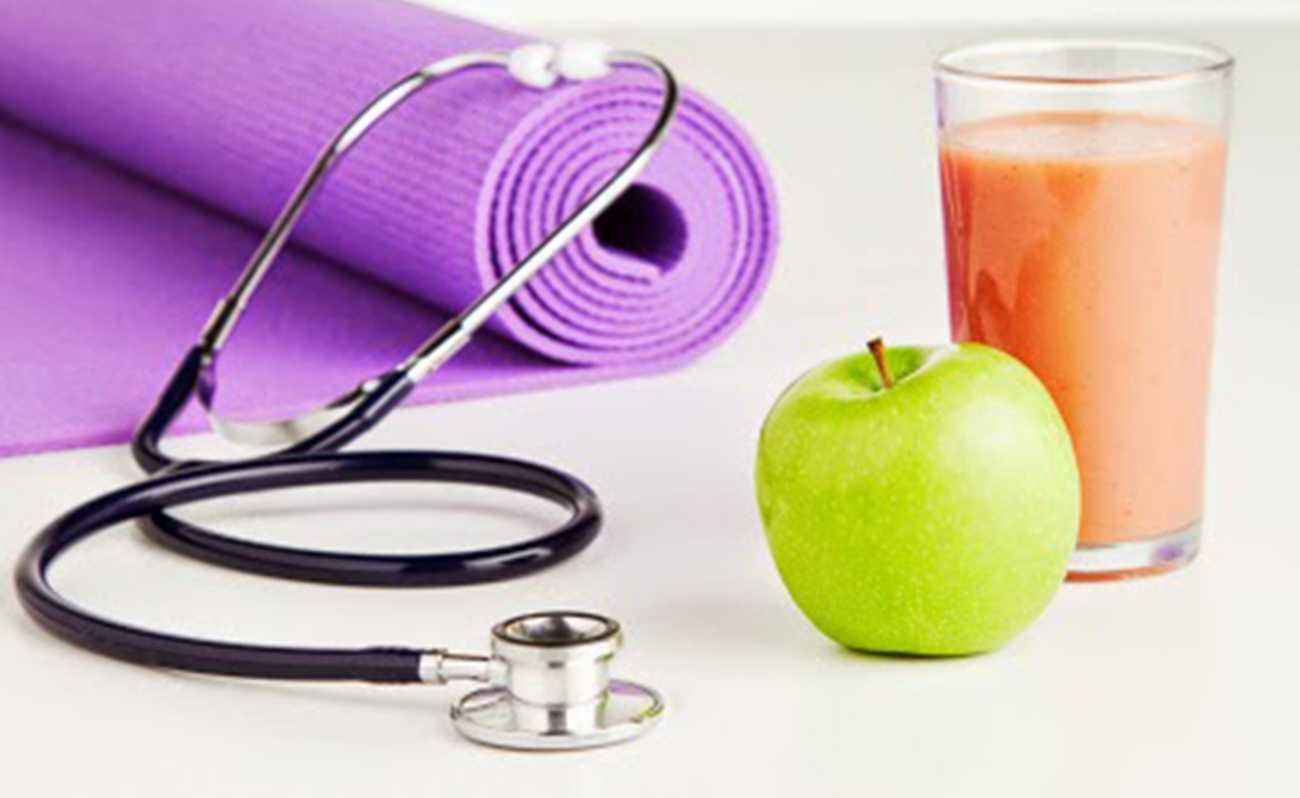 Apple, smoothie, stethoscope and yoga mat